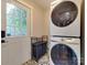 Laundry room with modern appliances, ample storage, and stylish tile flooring at 4216 Maureen Dr, Charlotte, NC 28205