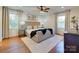 Bright bedroom featuring hardwood floors, a large bed, area rug, and dual windows with drapes at 4216 Maureen Dr, Charlotte, NC 28205