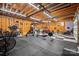 Large basement area with rubber flooring, a weightlifting set, and workout equipment at 4436 Roberta Rd, Concord, NC 28027