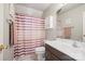 Bathroom featuring a purple and white striped shower curtain and a white vanity sink at 4436 Roberta Rd, Concord, NC 28027