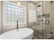 Bright bathroom with a soaking tub, walk-in shower, and a window that lets in natural light at 4436 Roberta Rd, Concord, NC 28027