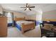 Bedroom with a wooden bed frame and two-tone walls, and a ceiling fan at 4436 Roberta Rd, Concord, NC 28027