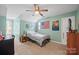 Cozy bedroom featuring light green walls, fun decor, and lots of natural light at 4436 Roberta Rd, Concord, NC 28027