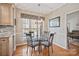 Cozy dining area featuring a glass table, decorative chandelier, and a window with natural light at 4436 Roberta Rd, Concord, NC 28027