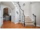 Bright and inviting foyer with hardwood floors, staircase, and a glimpse into the living room at 4436 Roberta Rd, Concord, NC 28027