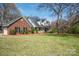 Charming two-story brick home boasts a well-manicured lawn, black shutters, and a welcoming front porch at 4436 Roberta Rd, Concord, NC 28027