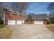 Multiple garage spaces with a wide driveway enhance this brick home's functionality and curb appeal at 4436 Roberta Rd, Concord, NC 28027