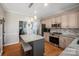 Charming kitchen with a granite island and barstool seating, stainless steel appliances, and hardwood floors at 4436 Roberta Rd, Concord, NC 28027