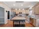 Bright kitchen featuring a granite island with seating, stainless steel appliances, and modern countertops at 4436 Roberta Rd, Concord, NC 28027