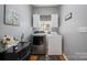 Laundry room with modern washer and dryer units, ample storage, and stylish decor at 4436 Roberta Rd, Concord, NC 28027