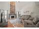 Spacious living room with vaulted ceilings, a wood-paneled fireplace, and ample natural light at 4436 Roberta Rd, Concord, NC 28027