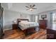 Spacious main bedroom boasts a tray ceiling, ceiling fan, and ample natural light, creating a serene retreat at 4436 Roberta Rd, Concord, NC 28027