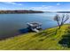 Aerial view of lake house with boat dock and waterfront access on a sunny day at 49461 River Run Rd, Albemarle, NC 28001