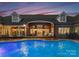 A gorgeous brick house with pool is set against a stunning sunset backdrop at 49461 River Run Rd, Albemarle, NC 28001