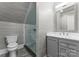 Bathroom showcasing modern shower with glass door, toilet, vanity, and gray walls at 49461 River Run Rd, Albemarle, NC 28001