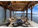 Picturesque covered boat dock with comfortable seating for relaxing by the water's edge at 49461 River Run Rd, Albemarle, NC 28001