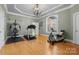 Bright exercise room with hardwood floors, tray ceiling, large window, and exercise equipment at 49461 River Run Rd, Albemarle, NC 28001