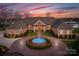 Grand circular driveway with fountain showcases the entrance of this luxurious brick home at 49461 River Run Rd, Albemarle, NC 28001