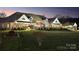 A well lit large home on a big lot that is beautifully landscaped and well-maintained at 49461 River Run Rd, Albemarle, NC 28001