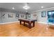 Game room with pool table, hard wood floors, artwork, lighting, and pinball machine at 49461 River Run Rd, Albemarle, NC 28001