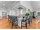 Open-concept kitchen island with counter seating and stainless steel sink at 49461 River Run Rd, Albemarle, NC 28001