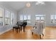 Inviting music room with a piano, comfortable seating, and views of the lake at 49461 River Run Rd, Albemarle, NC 28001