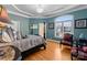 Bedroom with tray ceiling, hardwood floors, chandelier, and a large window at 49461 River Run Rd, Albemarle, NC 28001