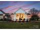 A covered outdoor kitchen and dining space is an entertainer's dream, with a great view at 49461 River Run Rd, Albemarle, NC 28001