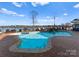 Beautiful in-ground pool area with brick surround, a waterfall feature, and scenic lake views at 49461 River Run Rd, Albemarle, NC 28001