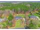 Stunning aerial view of a brick home with a well-manicured lawn and a forest backdrop at 514 Saint Johns Dr, Salisbury, NC 28144