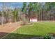 Spacious backyard with a storage building and a fire pit area, great for outdoor activities at 514 Saint Johns Dr, Salisbury, NC 28144