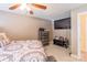 Comfortable bedroom features a large TV, dresser, ceiling fan, and a well-dressed bed for relaxation at 514 Saint Johns Dr, Salisbury, NC 28144