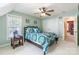 Inviting bedroom features an accent-colored wall, colorful bedding, and a ceiling fan, for a cozy retreat at 514 Saint Johns Dr, Salisbury, NC 28144