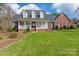 Beautiful brick home with a spacious front yard, covered porch, and charming architectural details at 514 Saint Johns Dr, Salisbury, NC 28144