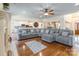 Open-concept living room with a view of the kitchen, hardwood floors, and a comfortable sectional sofa at 514 Saint Johns Dr, Salisbury, NC 28144