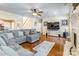 Spacious living room with hardwood floors, ceiling fan, and a comfortable gray sectional sofa at 514 Saint Johns Dr, Salisbury, NC 28144