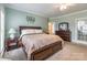 Comfortable main bedroom featuring plush carpet, a ceiling fan, and a wooden bed with side tables at 514 Saint Johns Dr, Salisbury, NC 28144