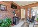 Brick sunroom featuring a mini fridge, TV and decorative elements at 514 Saint Johns Dr, Salisbury, NC 28144