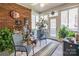 Bright sunroom with brick accent wall and views of the outdoor landscape at 514 Saint Johns Dr, Salisbury, NC 28144