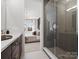 Modern bathroom featuring a glass shower and partial view of a beautifully furnished bedroom at 5719 Castlerea Dr, Charlotte, NC 28217