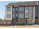 Modern townhome exterior featuring a stylish facade, multi-story design, and inviting entrance, showcasing contemporary curb appeal at 5719 Castlerea Dr, Charlotte, NC 28217