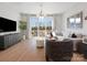 Bright living room with hardwood floors, modern decor, and a sliding glass door leading to a balcony at 5719 Castlerea Dr, Charlotte, NC 28217