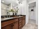 Bathroom features a double sink vanity with gray countertops, wood cabinets, and a glass shower at 5731 Castlerea Dr, Charlotte, NC 28217