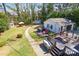 Aerial view of landscaped backyard featuring a deck, patio furniture, fire pit, and storage shed at 5943 Charing Pl, Charlotte, NC 28211