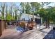 Back deck with wooden railing, table and chairs with an outdoor dining area, perfect for entertaining at 5943 Charing Pl, Charlotte, NC 28211