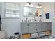 Bright bathroom featuring a gray double vanity with a large mirror and stylish decor at 5943 Charing Pl, Charlotte, NC 28211