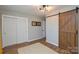 Spacious bedroom featuring a barn door, closet, and ample natural light, creating a serene space at 5943 Charing Pl, Charlotte, NC 28211