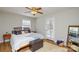 Bright bedroom showcasing natural light, a ceiling fan, a comfortable bed, and modern decor at 5943 Charing Pl, Charlotte, NC 28211