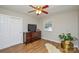 Well-lit bedroom with natural light, hardwood floors, and a TV on a dresser, creating a comfortable retreat at 5943 Charing Pl, Charlotte, NC 28211