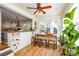 Bright breakfast nook features a wood table with seating bench, open to the kitchen, and filled with natural light at 5943 Charing Pl, Charlotte, NC 28211